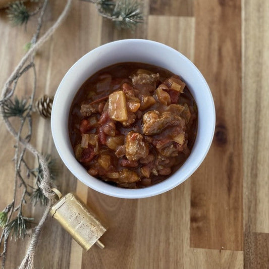 Bowl of chili on a wooden table
