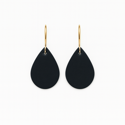 Black leather teardrop earrings with gold-plated stainless steel hooks on a white background.