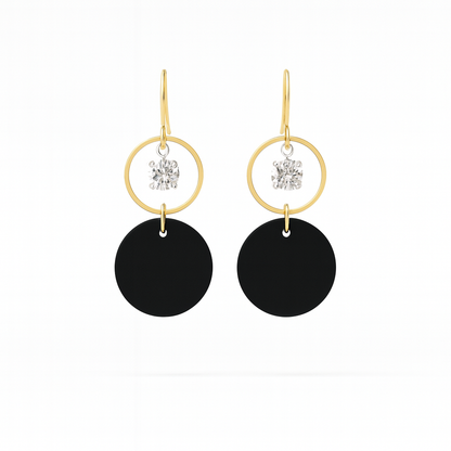 A pair of black leather statement earrings featuring gold-plated rings and crystal details on a white background.