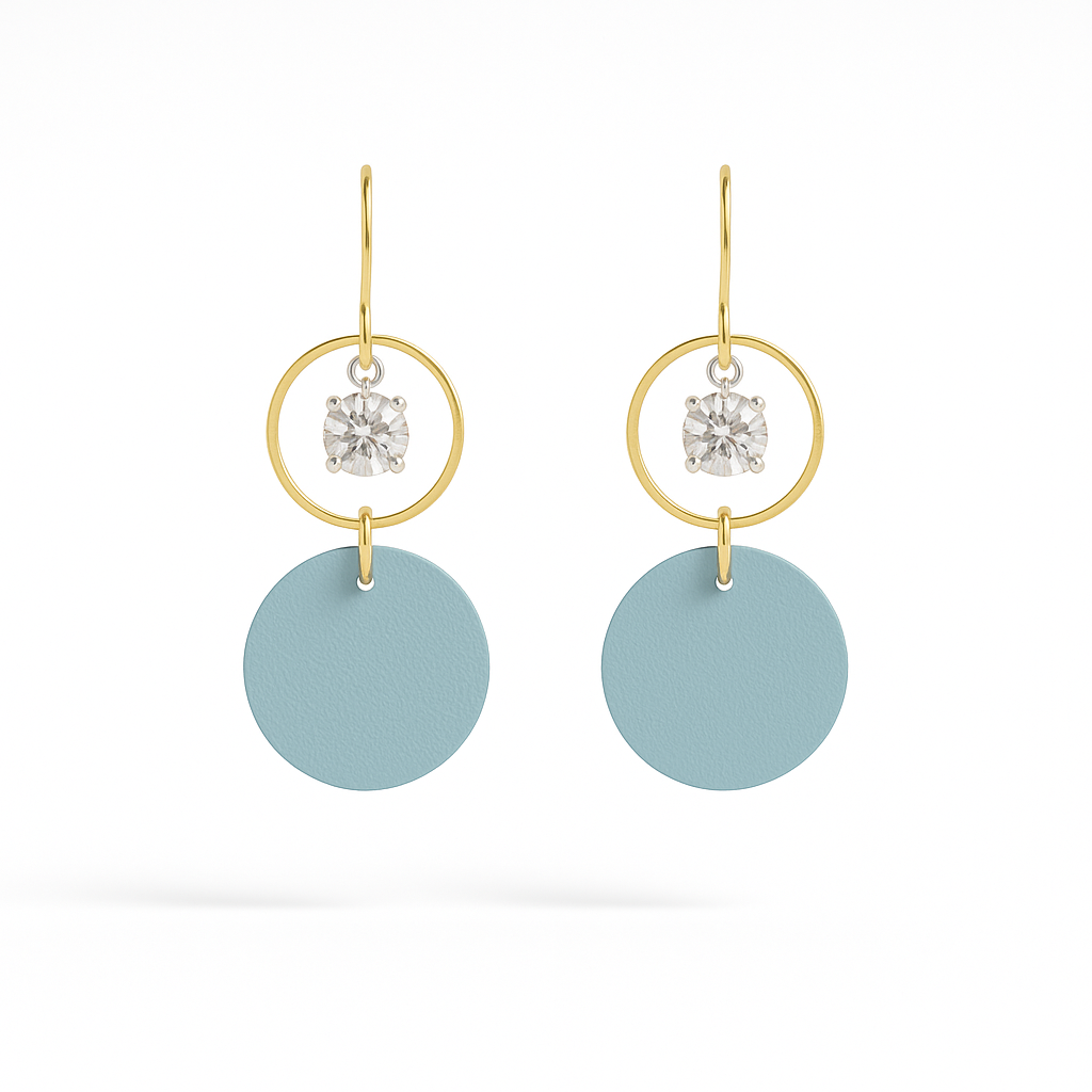 A pair of blue leather statement earrings featuring gold-plated rings and crystal details on a white background.