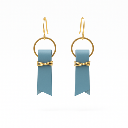 A pair of blue leather ribbon earrings accented with gold-plated wire and rings on a white background.