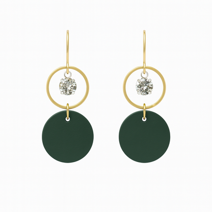 A pair of green leather statement earrings featuring gold-plated rings and crystal details on a white background.