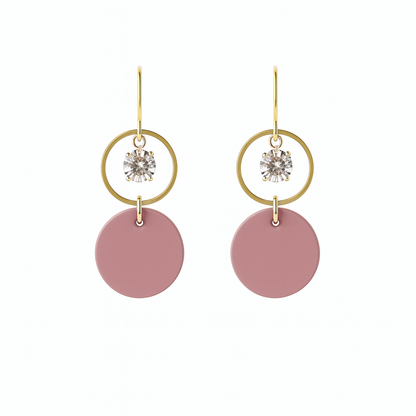 A pair of mauve leather statement earrings featuring gold-plated rings and crystal details on a white background.