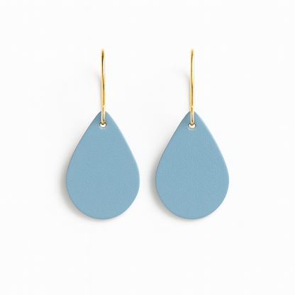 Pair of blue leather teardrop earrings with gold-plated stainless steel hooks on a white background.
