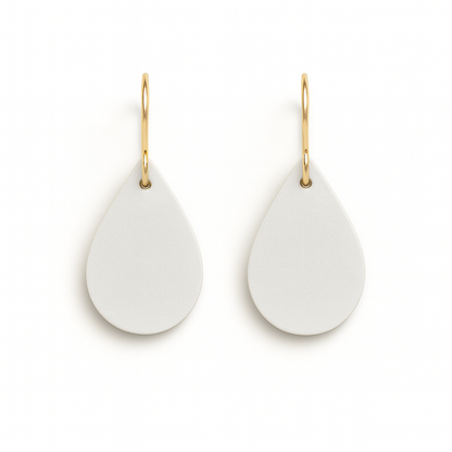 A pair of off-white teardrop earrings with gold-plated stainless steel hooks on a white background.