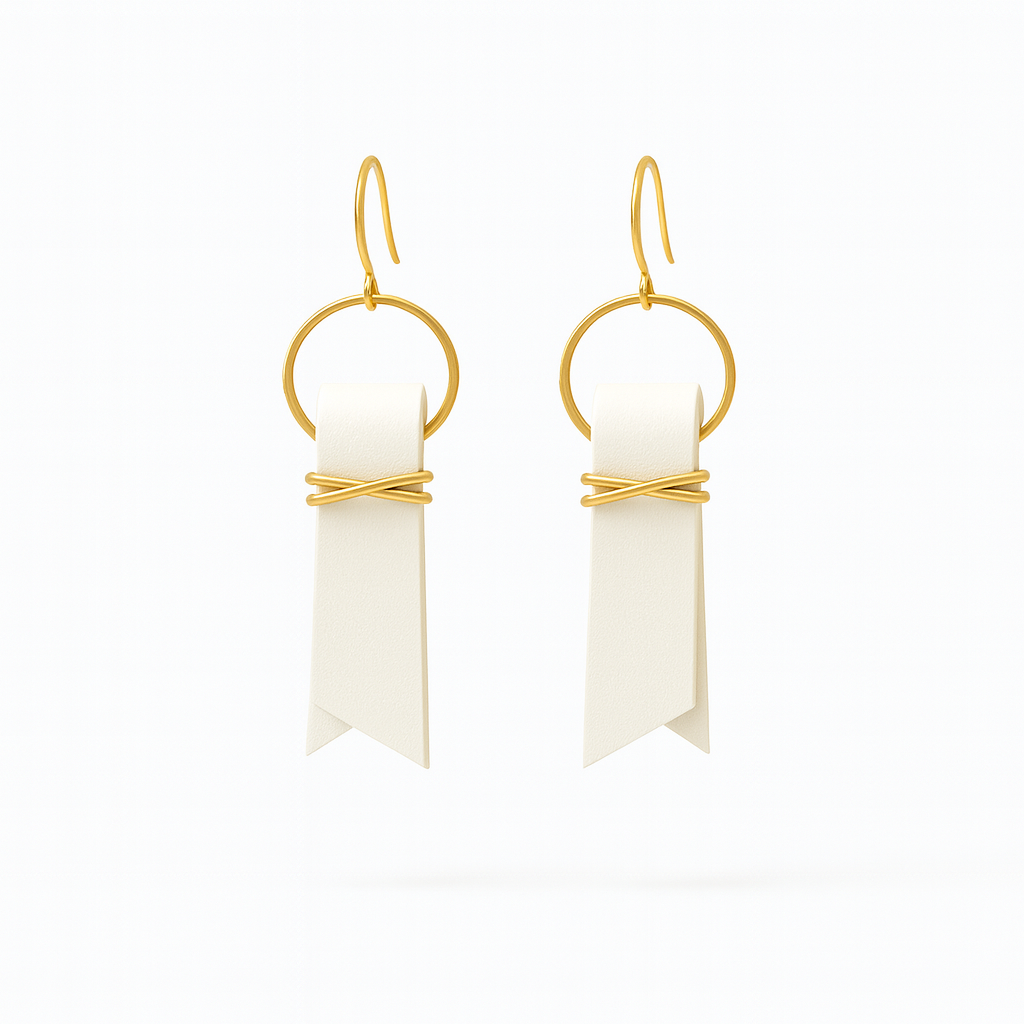 Off-white leather ribbon earrings accented with gold-plated wire and rings on a white background.
