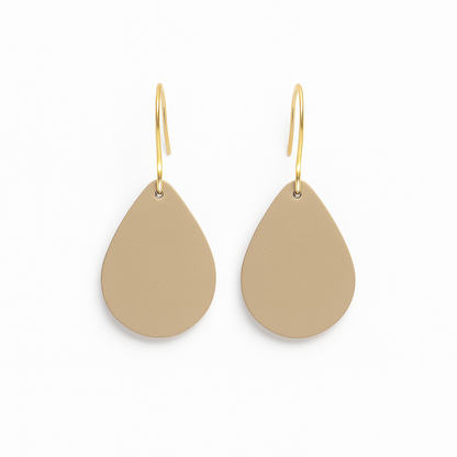 A pair of beige leather teardrop earrings with gold-plated stainless steel hooks on a white background.