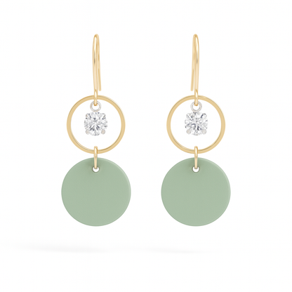 Seafoam green leather statement earrings featuring gold-plated rings and crystal details on a white background.