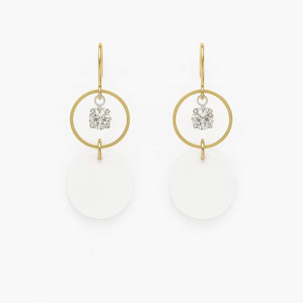 White leather statement earrings featuring gold-plated rings and crystal details on a white background.