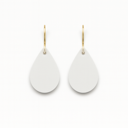 A pair of white leather teardrop earrings with gold-plated stainless steel hooks on a white background.