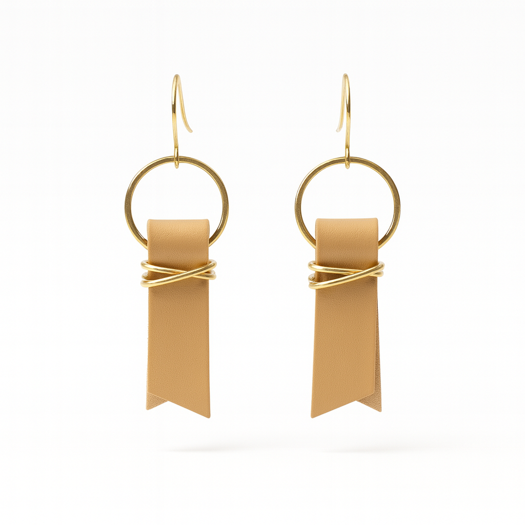 A pair of yellow leather ribbon earrings accented with gold-plated wire and rings on a white background.